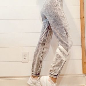 grey sweatpants with white athletic stripes